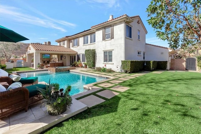 back of house featuring a yard, outdoor lounge area, a fenced in pool, and a patio area