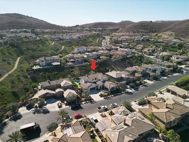 birds eye view of property with a mountain view