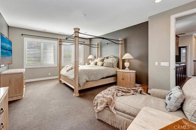 bedroom featuring visible vents, baseboards, and dark colored carpet