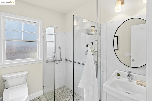 bathroom with toilet, tile patterned floors, sink, and a tile shower