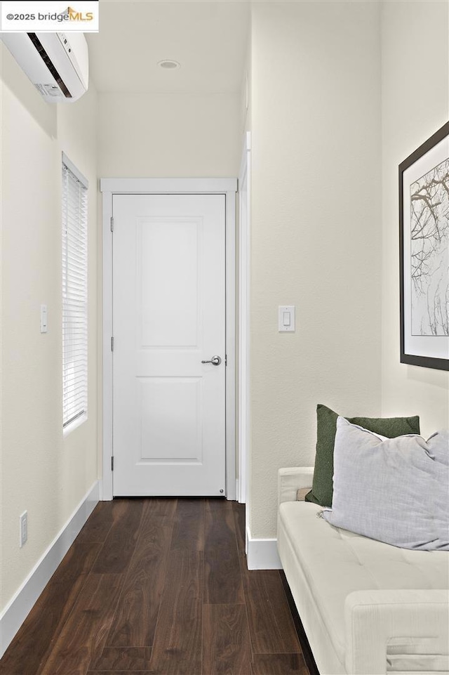 hall featuring dark hardwood / wood-style floors and a wall mounted AC