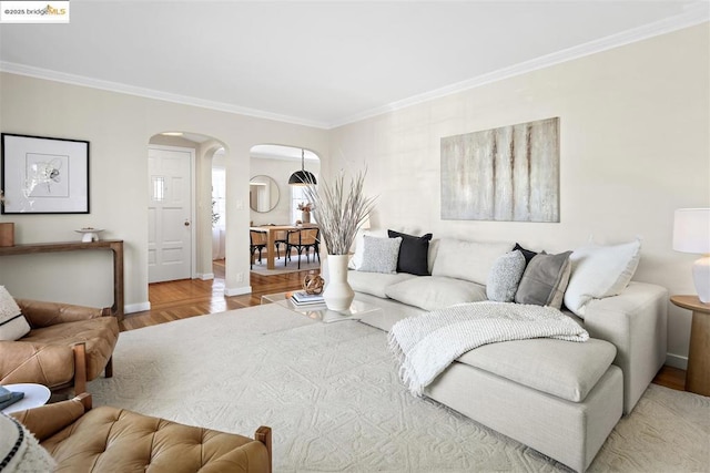 living room featuring light hardwood / wood-style flooring and ornamental molding