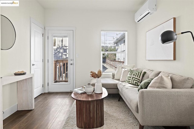 living room with a wall mounted AC and wood-type flooring