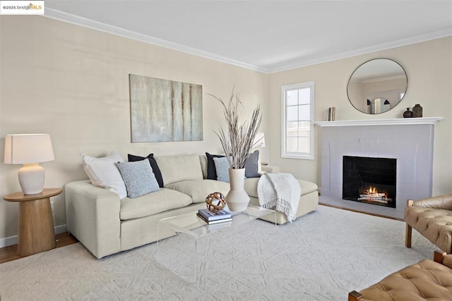 living room with a brick fireplace, crown molding, and light hardwood / wood-style floors