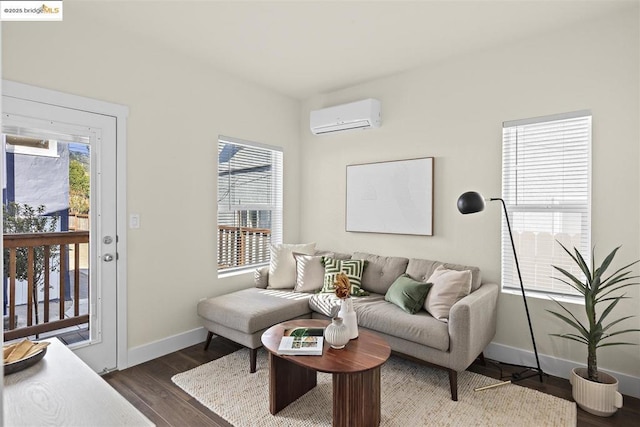 living room with a wall mounted AC and dark hardwood / wood-style floors