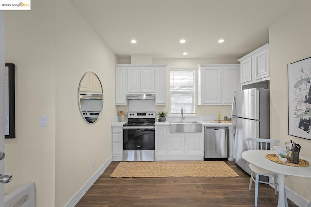 kitchen featuring dark hardwood / wood-style flooring, sink, stainless steel appliances, and white cabinetry