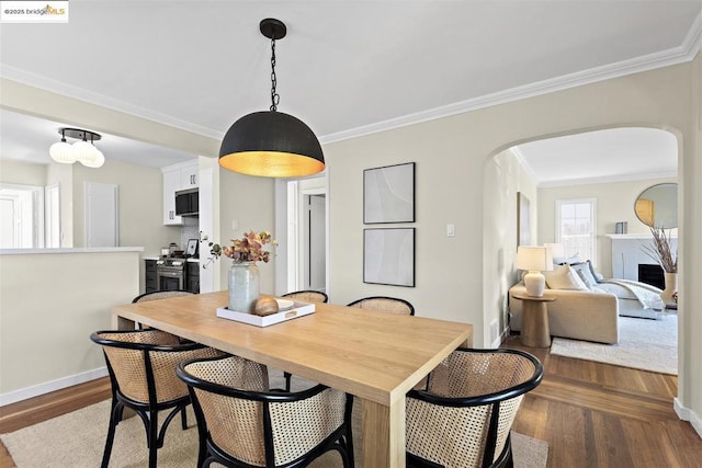 dining area featuring ornamental molding and hardwood / wood-style flooring