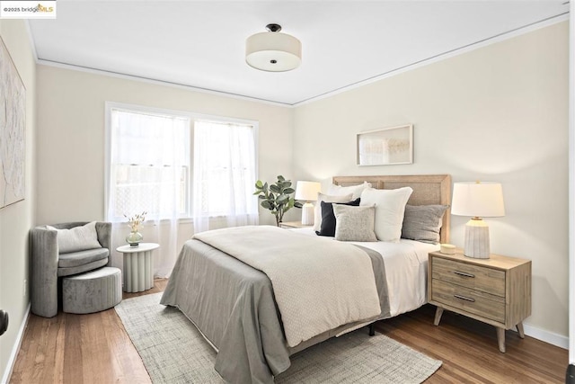 bedroom with ornamental molding and light hardwood / wood-style flooring