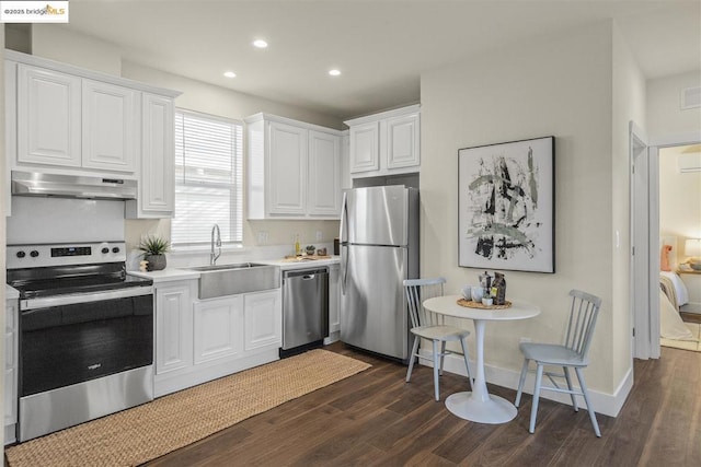 kitchen with stainless steel appliances, dark hardwood / wood-style flooring, white cabinetry, and sink