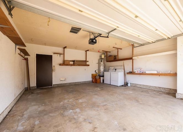 garage with washer and clothes dryer, a garage door opener, and secured water heater