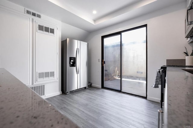 interior space featuring stainless steel appliances and light hardwood / wood-style flooring