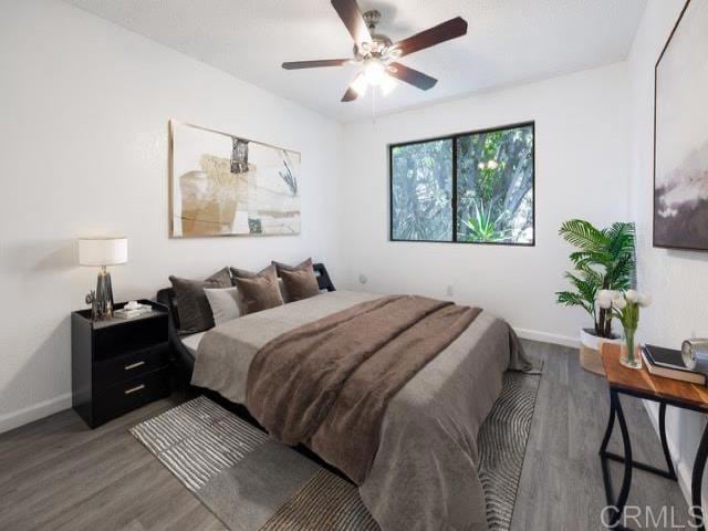 bedroom with ceiling fan and wood-type flooring