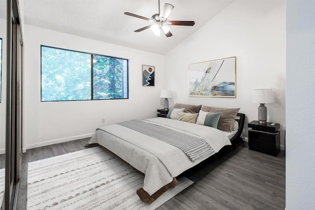 bedroom featuring ceiling fan, wood-type flooring, and lofted ceiling