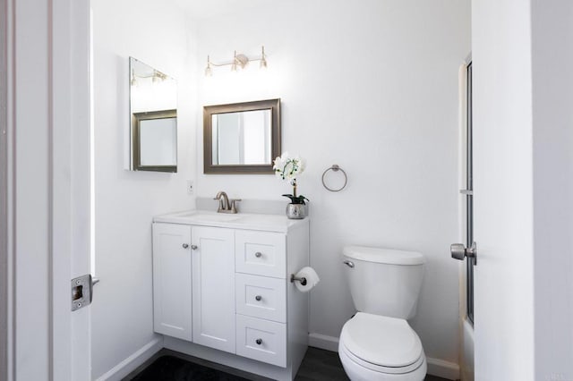 full bathroom with toilet, vanity, and shower / bath combination with glass door