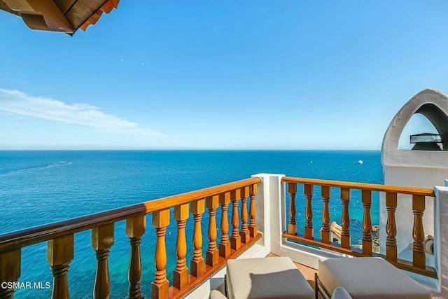 balcony featuring a water view