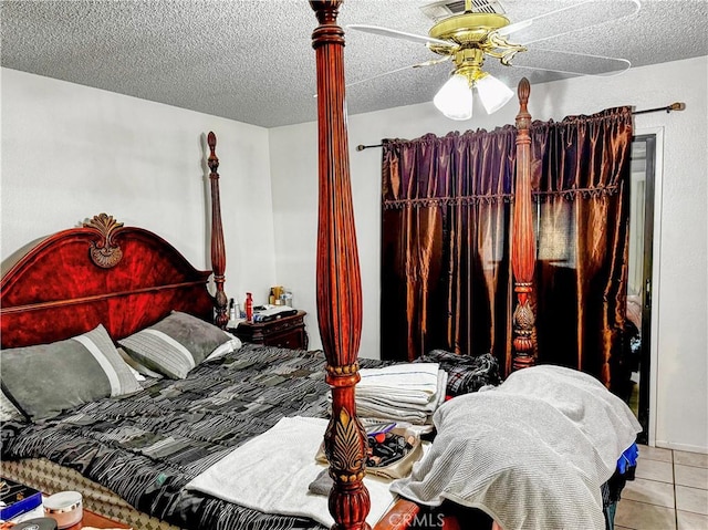 tiled bedroom with a textured ceiling and ceiling fan