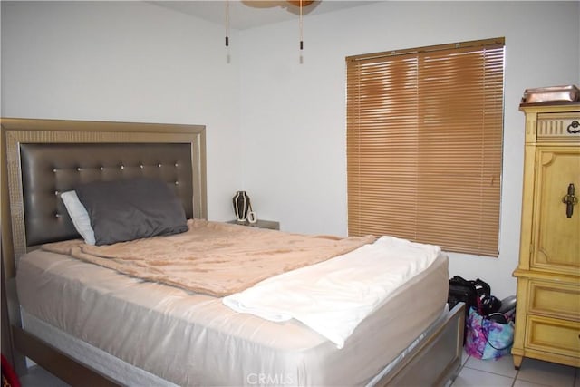 bedroom with ceiling fan and light tile patterned floors