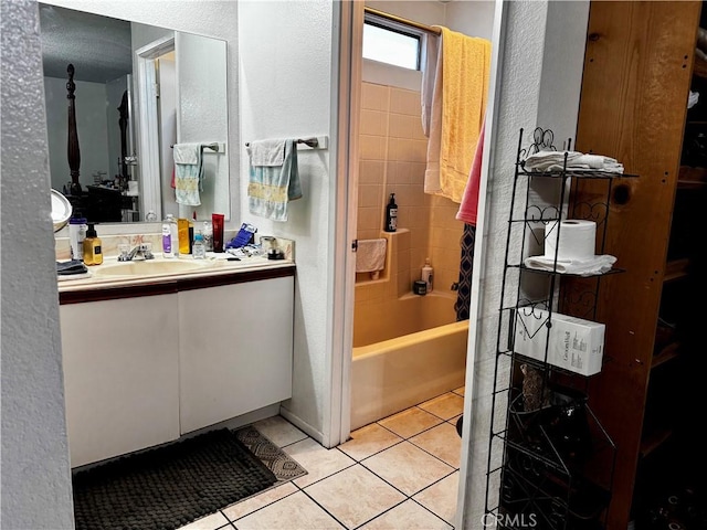 bathroom featuring vanity, tile patterned flooring, and washtub / shower combination