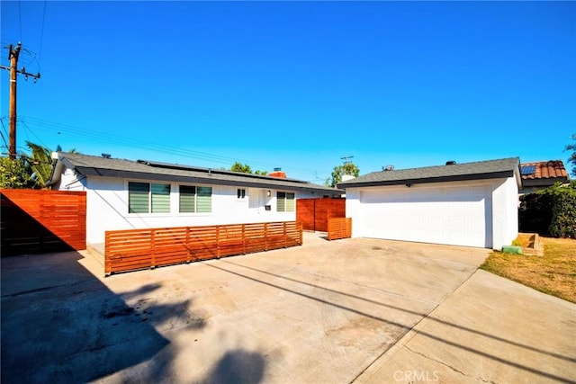 ranch-style house with a garage and an outdoor structure