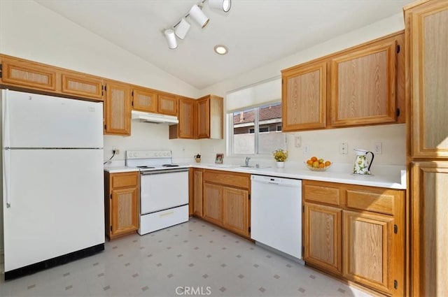 kitchen featuring vaulted ceiling, sink, and white appliances