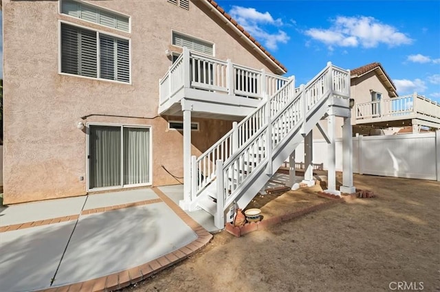 rear view of house with a deck and a patio area