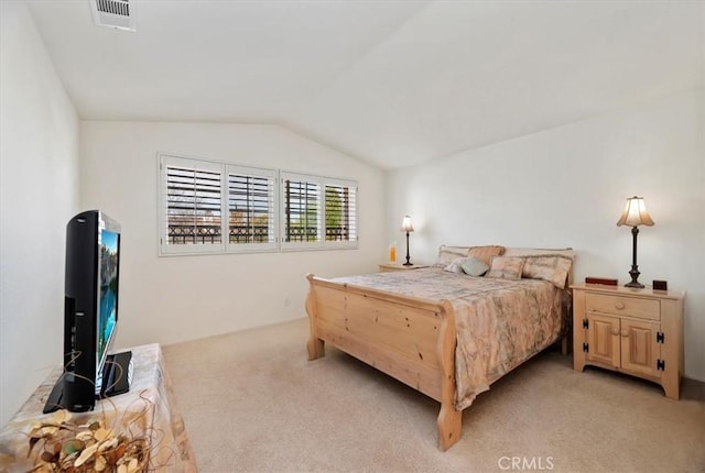 carpeted bedroom with lofted ceiling