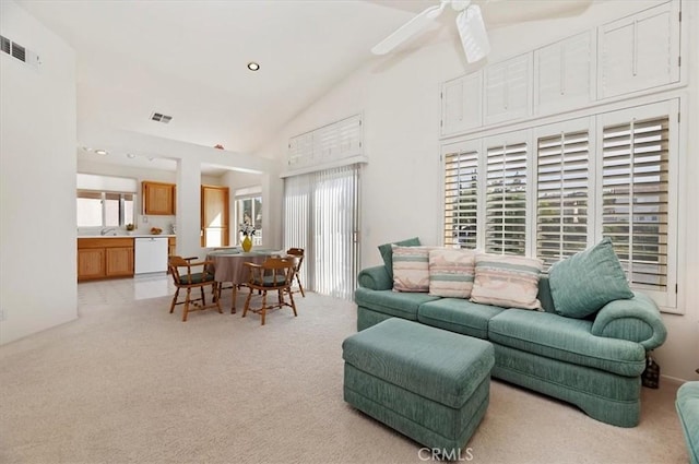 carpeted living room featuring ceiling fan, a wealth of natural light, and lofted ceiling