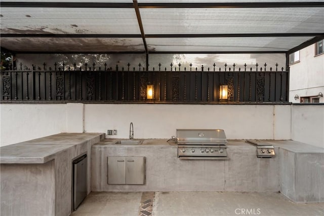 view of patio featuring an outdoor kitchen, sink, and grilling area