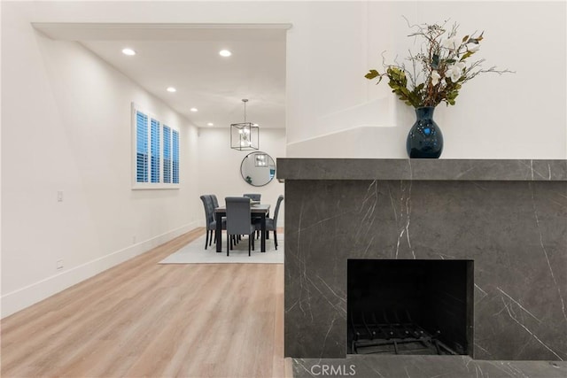 interior space featuring a premium fireplace and hardwood / wood-style flooring