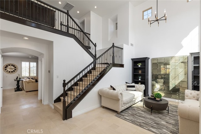 interior space with tile patterned flooring, a high ceiling, and a notable chandelier