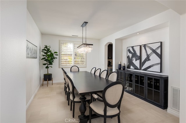 dining area featuring a notable chandelier