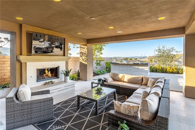 view of patio / terrace featuring an outdoor living space with a fireplace