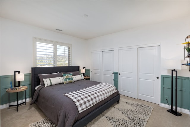 carpeted bedroom with multiple closets