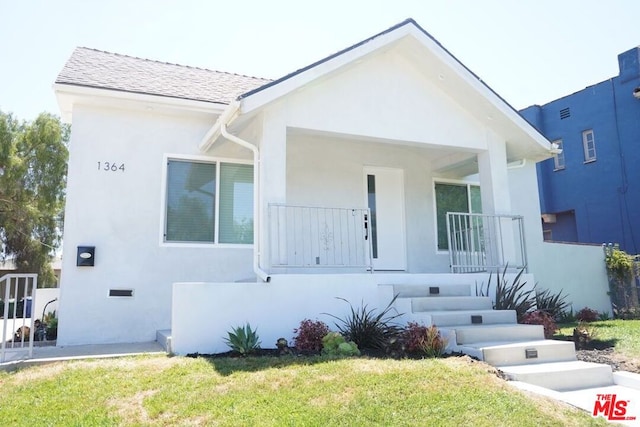 view of front of property with a porch and a front yard