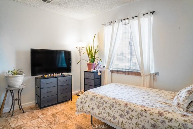 bedroom featuring a textured ceiling