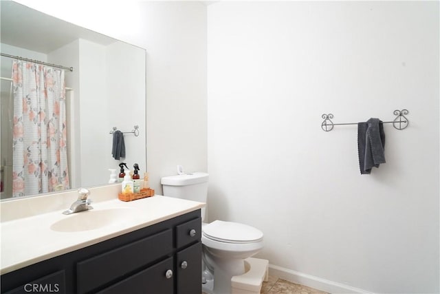 bathroom featuring tile patterned floors, vanity, curtained shower, and toilet