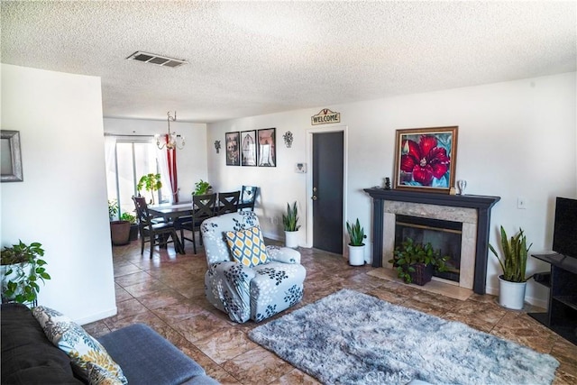 living room featuring a premium fireplace and a textured ceiling