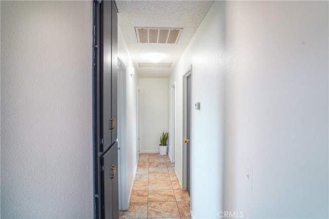 corridor with a textured ceiling