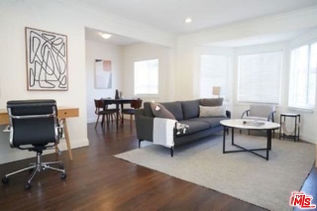 living room with crown molding and dark hardwood / wood-style floors