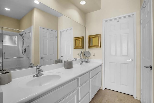 bathroom with a shower with door and vanity