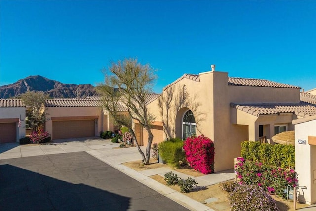 view of front of home with a mountain view and a garage