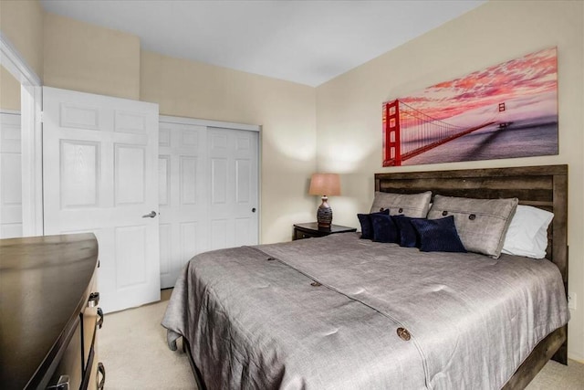 bedroom with light colored carpet and a closet