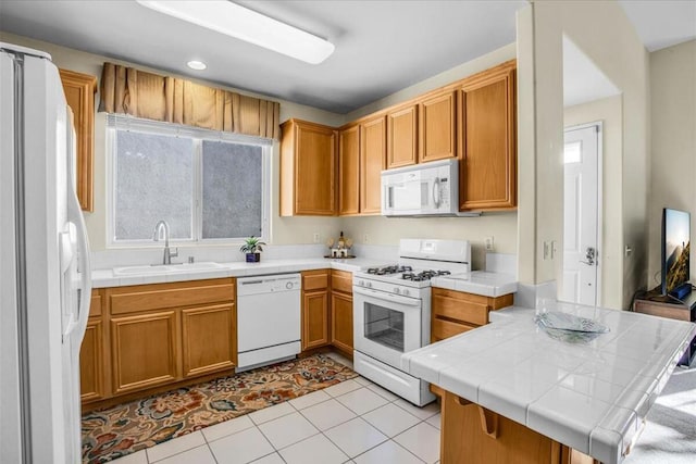 kitchen with tile counters, sink, kitchen peninsula, white appliances, and light tile patterned floors