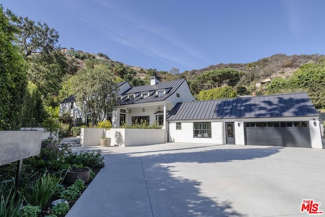 view of front facade with a mountain view and a garage