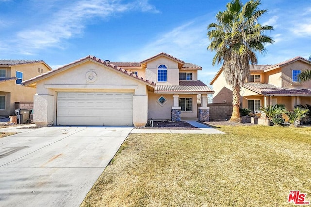 mediterranean / spanish house with a front lawn and a garage