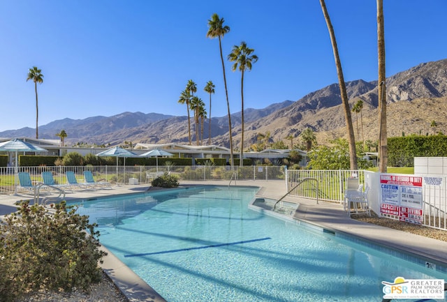 view of swimming pool with a mountain view