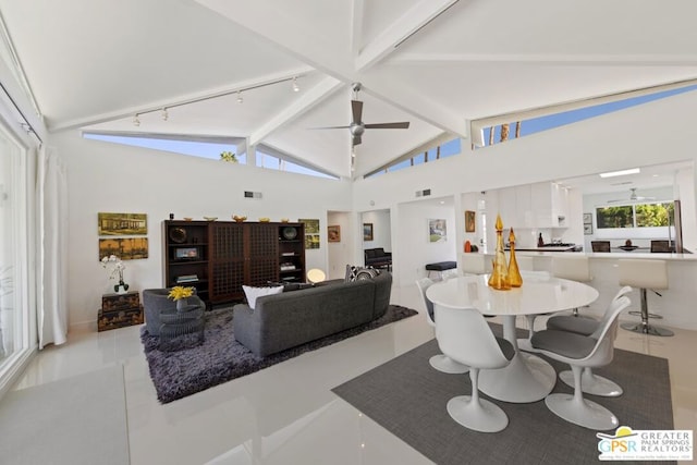 dining room featuring beam ceiling, ceiling fan, light tile patterned floors, and high vaulted ceiling