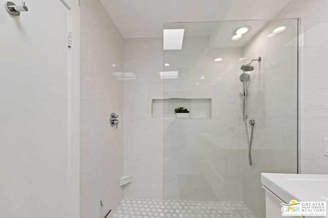 bathroom with tiled shower