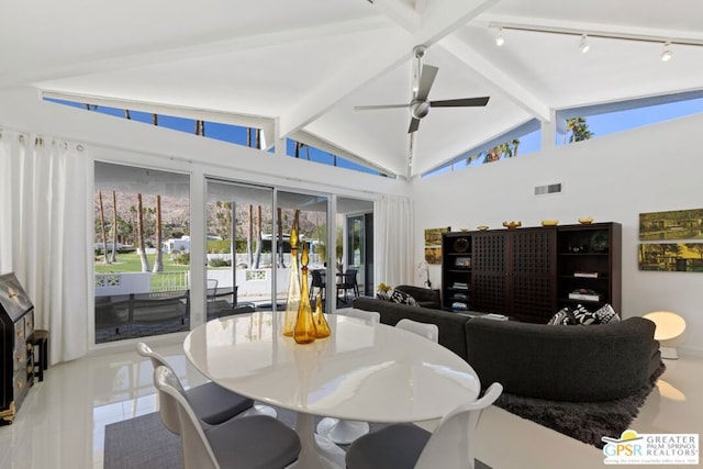 tiled dining area featuring vaulted ceiling with beams and ceiling fan