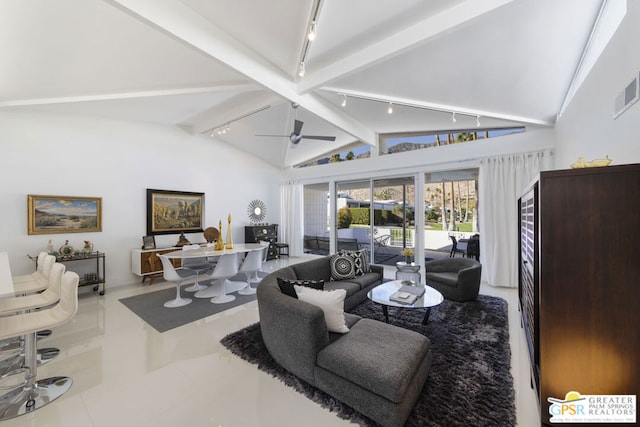 tiled living room with vaulted ceiling with beams, ceiling fan, and rail lighting